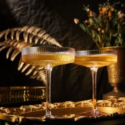 The Wine Savant Ribbed Coupe Cocktail Glasses 8 Oz | Set Of 2 | Classic Manhattan Glasses For Cocktails, Champagne Coupe, Ripple Coupe Glasses, Art Deco Gatsby Vintage, Crystal With Stems (Rose Pink) -Refined Spirits Store pink ribbed 2 1